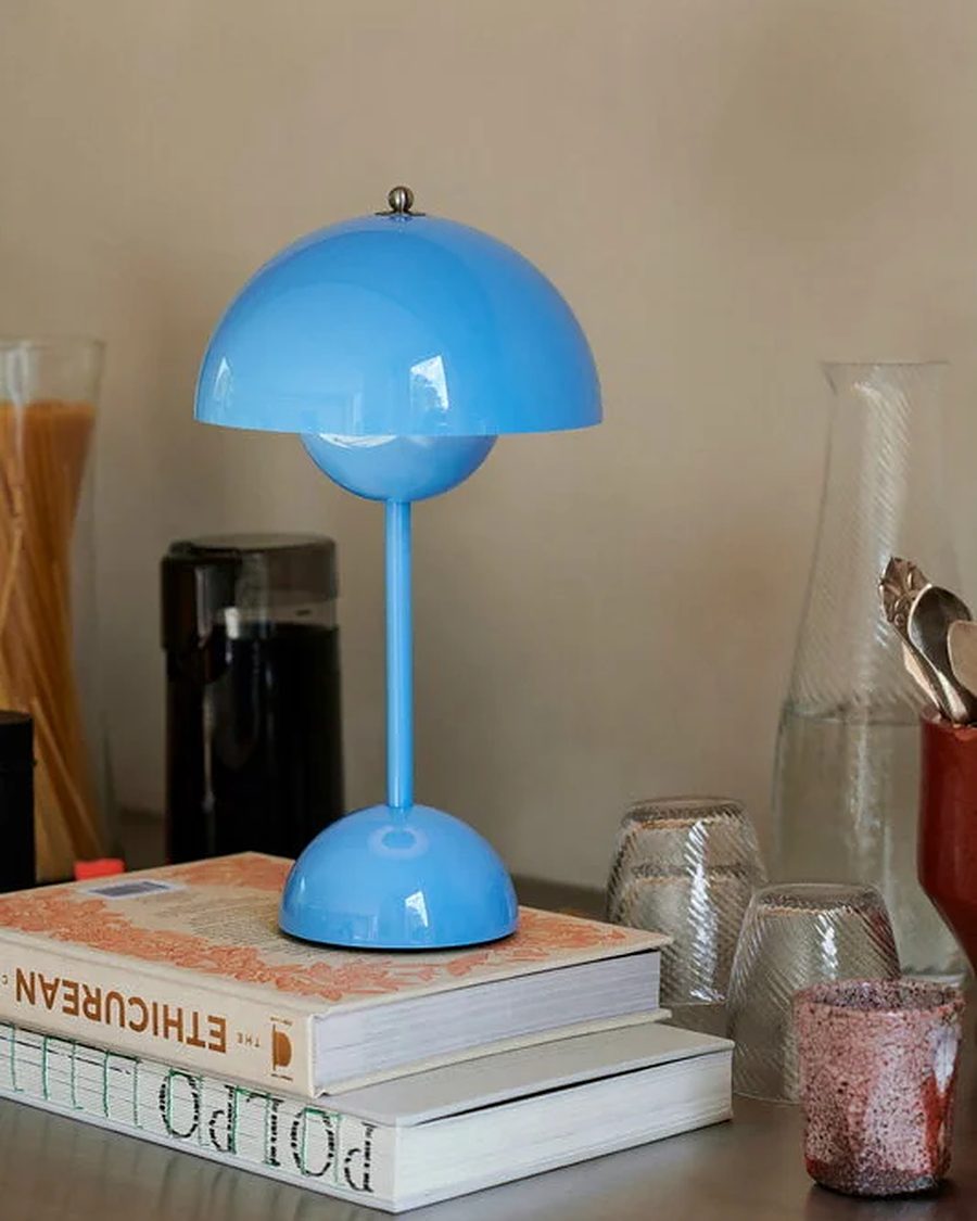 &Tradition Flowerpot VP9 portable lamp in Swim Blue on a stack of books